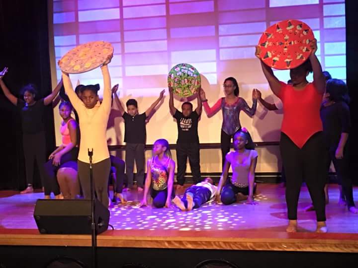 Students perform onstage during BHM Performance