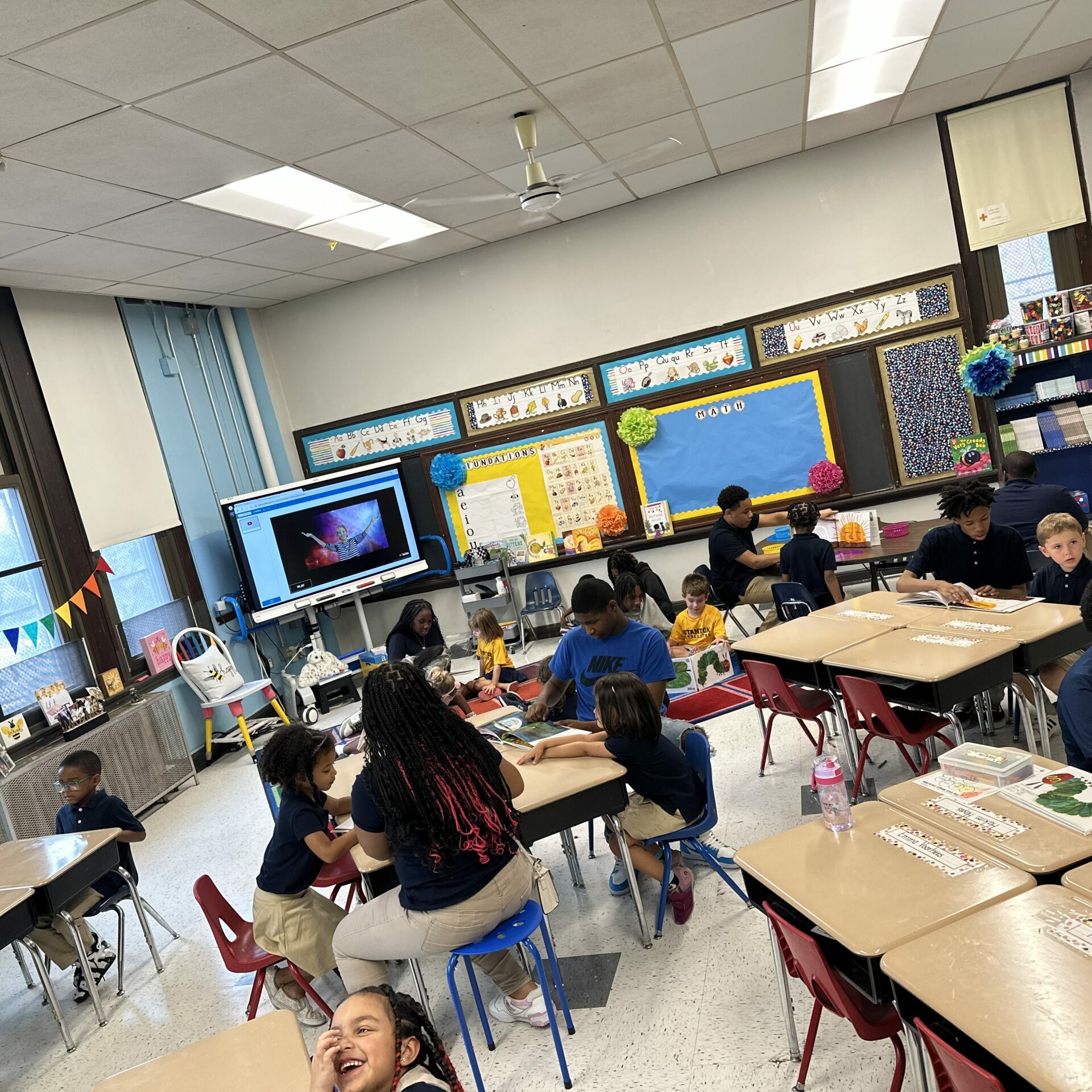 Students at Edwin M. Stanton School participate in collaborative reading and classroom learning activities in an elementary classroom.
